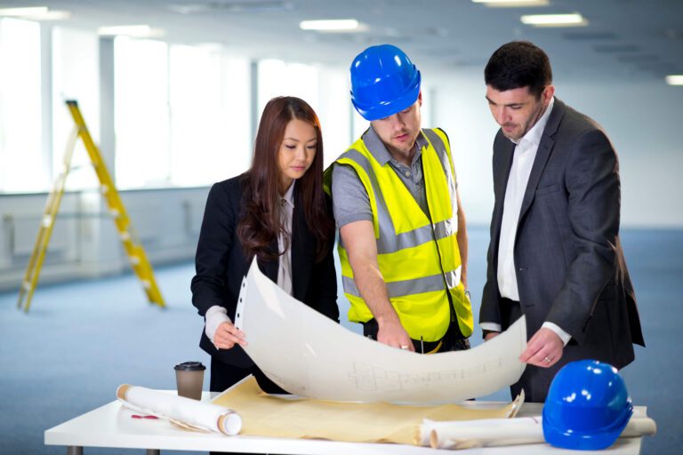 Commercial building inspection team reviewing plans during a construction inspection and documentation handover.