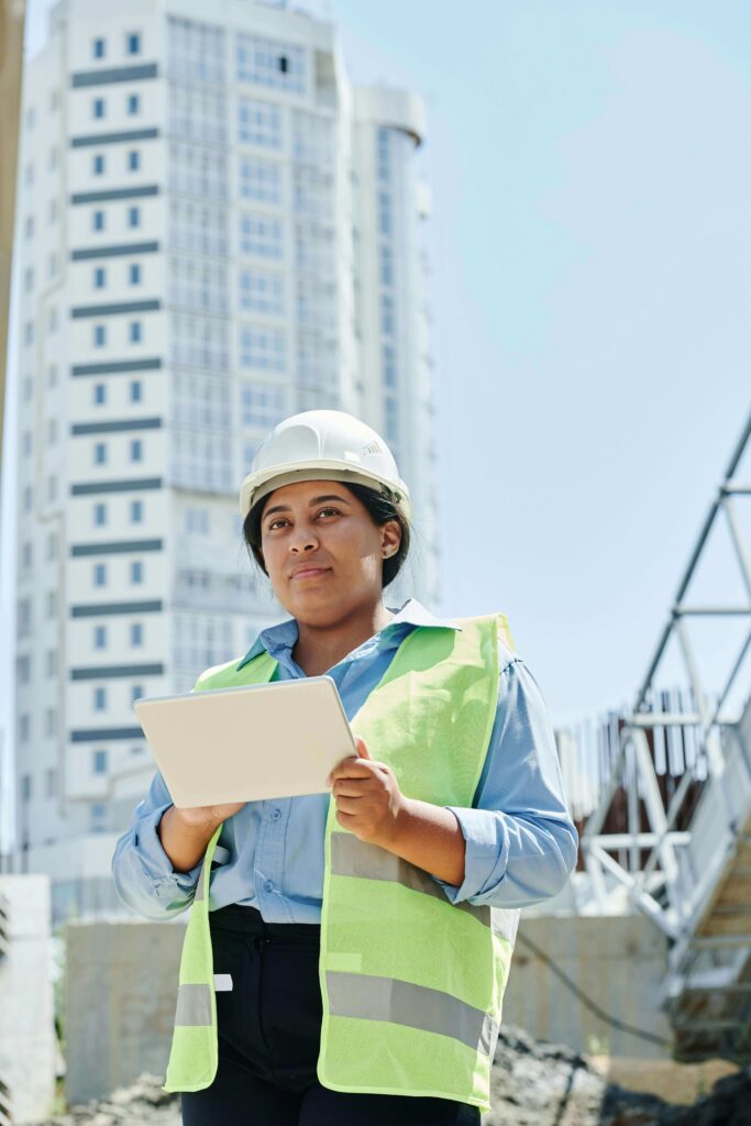 A supervisor implementing a risk-based inspection program using a mobile device at a large-scale construction site.