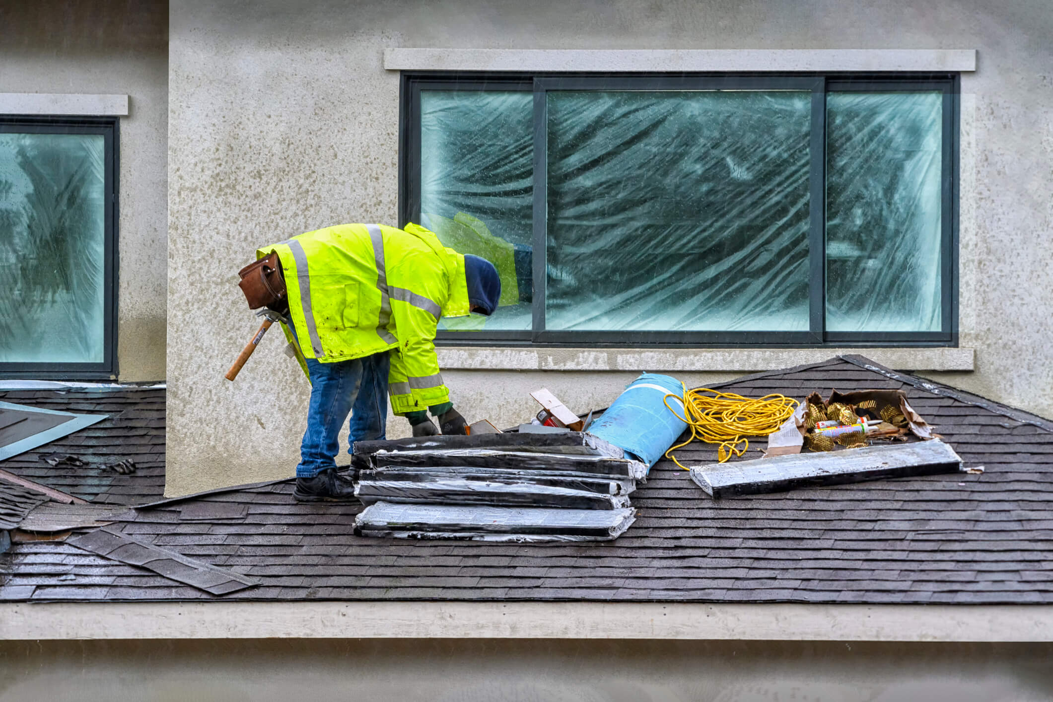 Roofing contractor completing roofing work during storm season preparation