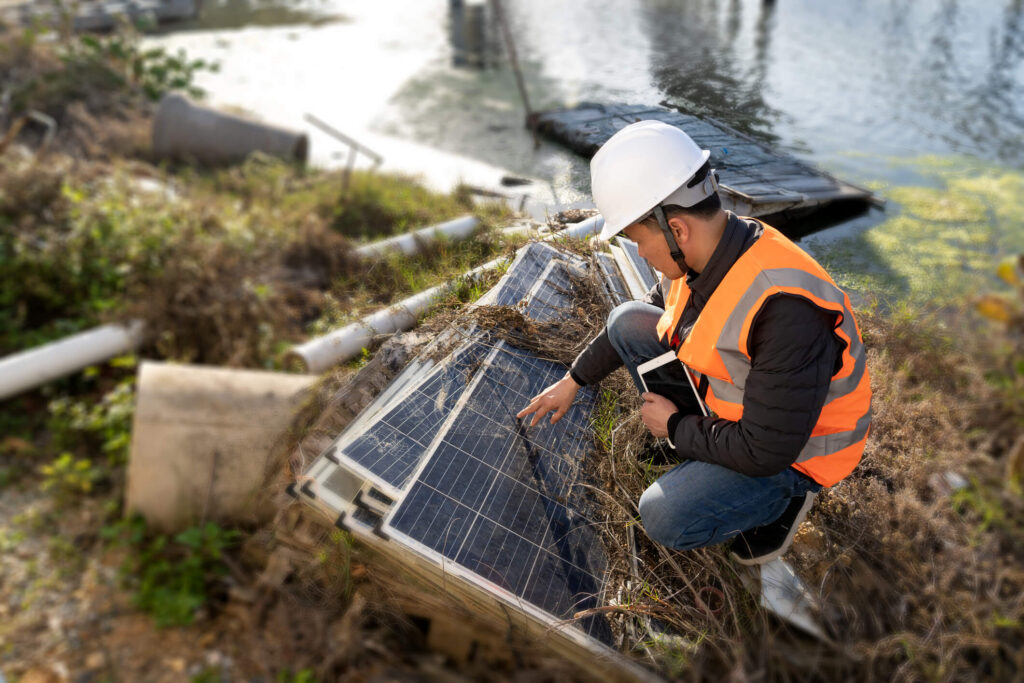 Solar panel inspector assessing storm damage after a hurricane