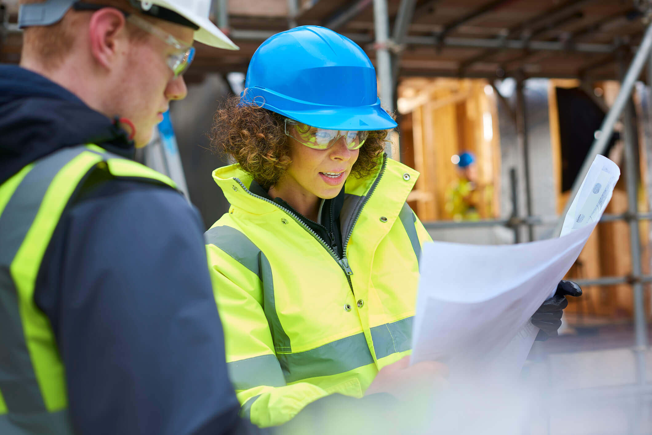 Contractors reviewing blueprints on a Florida job site under BOAF and HB 803 private provider authorization requirements